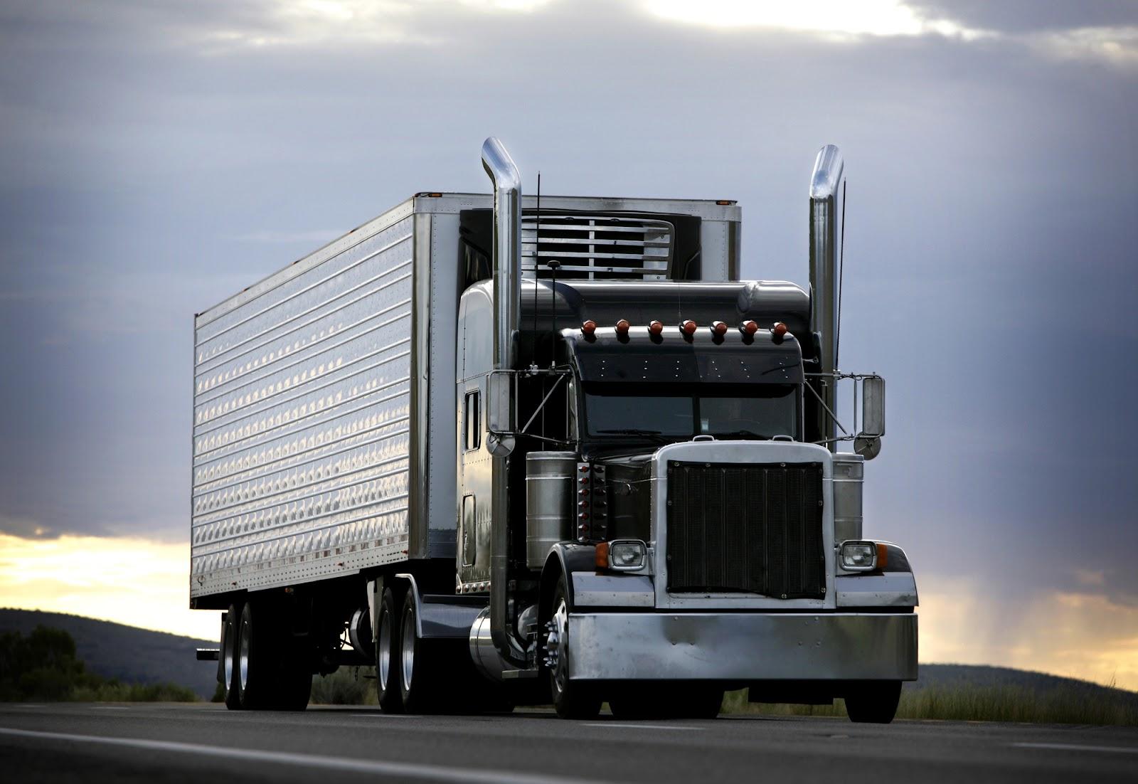 A semi-truck driving on the highway.