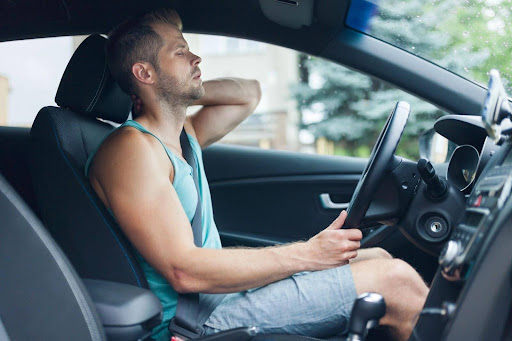 A man rubs his sore neck after a car accident. Pain and suffering compensation is a noneconomic damage that compensates you for emotional and mental trauma, physical pain, and more.