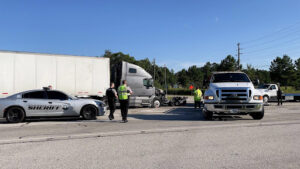 Truck accident, police car, and response team.